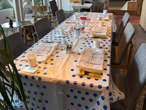 Café table set with VIBEZ kits and polka dot cloth before a session