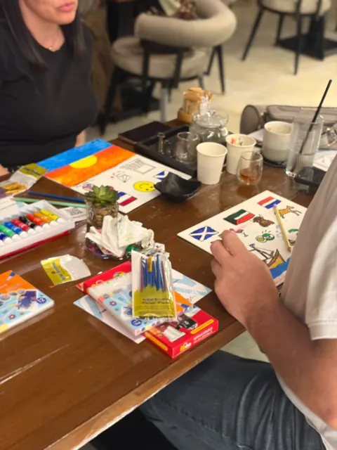 Guests painting colourful abstract canvases at a Vibez café session
