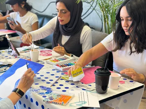 Group painting together at a creative team building session